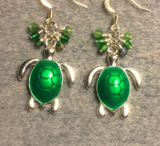 Bright green enamel sea turtle charm earrings adorned with small dangling green Czech glass beads.