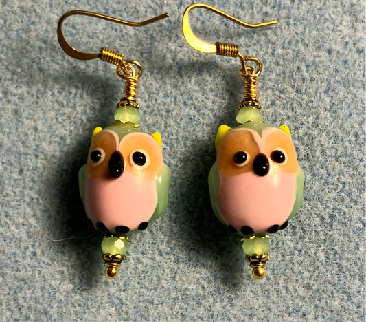 Pink and green lamp work owl bead earrings adorned with green Chinese crystal beads.