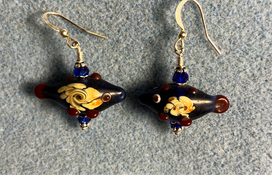 Dark blue lamp work fish bead earrings adorned with dark blue Chinese crystal beads.
