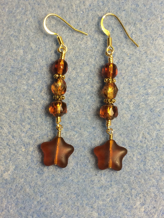 Small matte dark topaz Czech glass star bead earrings adorned with dark topaz Czech glass beads.