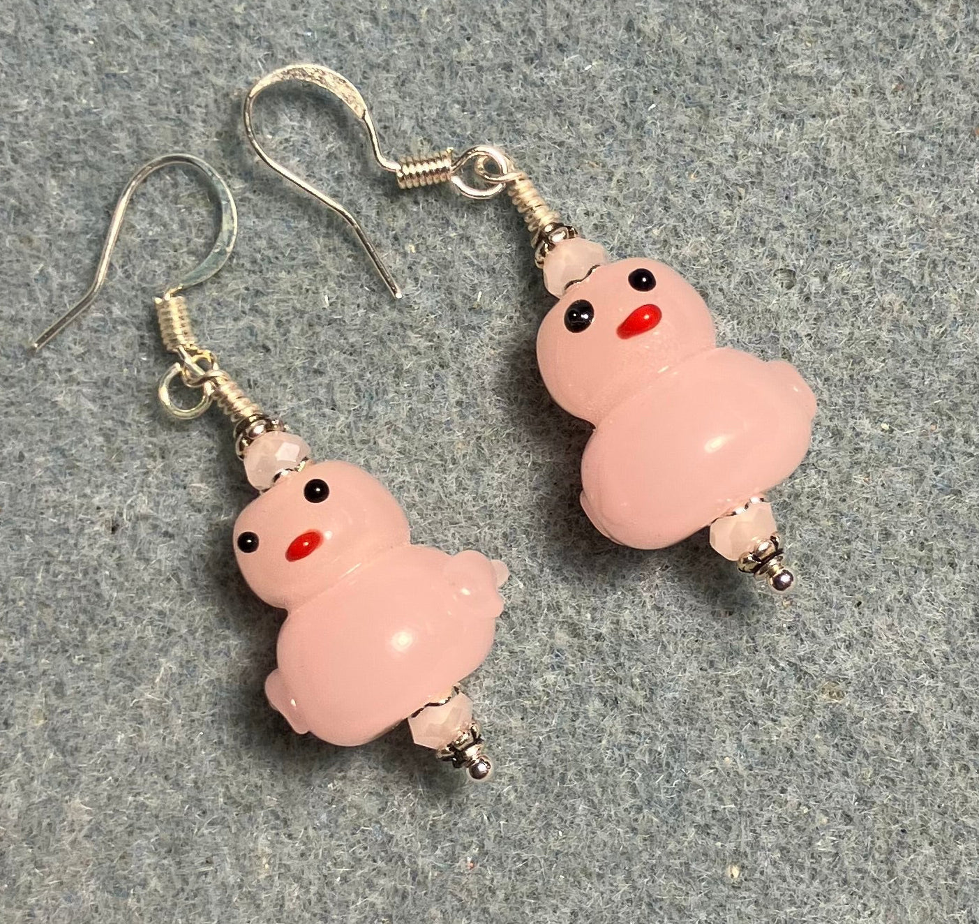 Opaque pink lamp work duck bead earrings adorned with pink Chinese crystal beads.