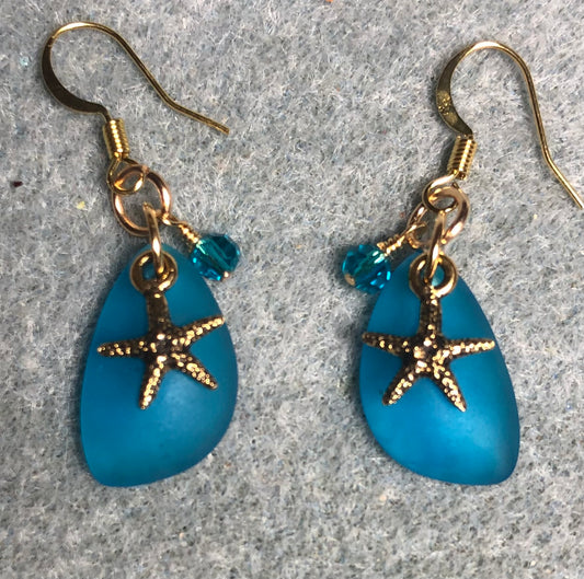 Small dark turquoise sea glass pendant bead earrings adorned with small gold starfish charms and dark turquoise Chinese crystal beads.