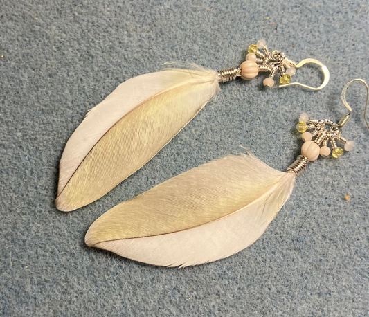 White and yellow cockatiel feather earrings adorned with white Czech glass melon beads and tiny dangling white and yellow Chinese crystal beads.