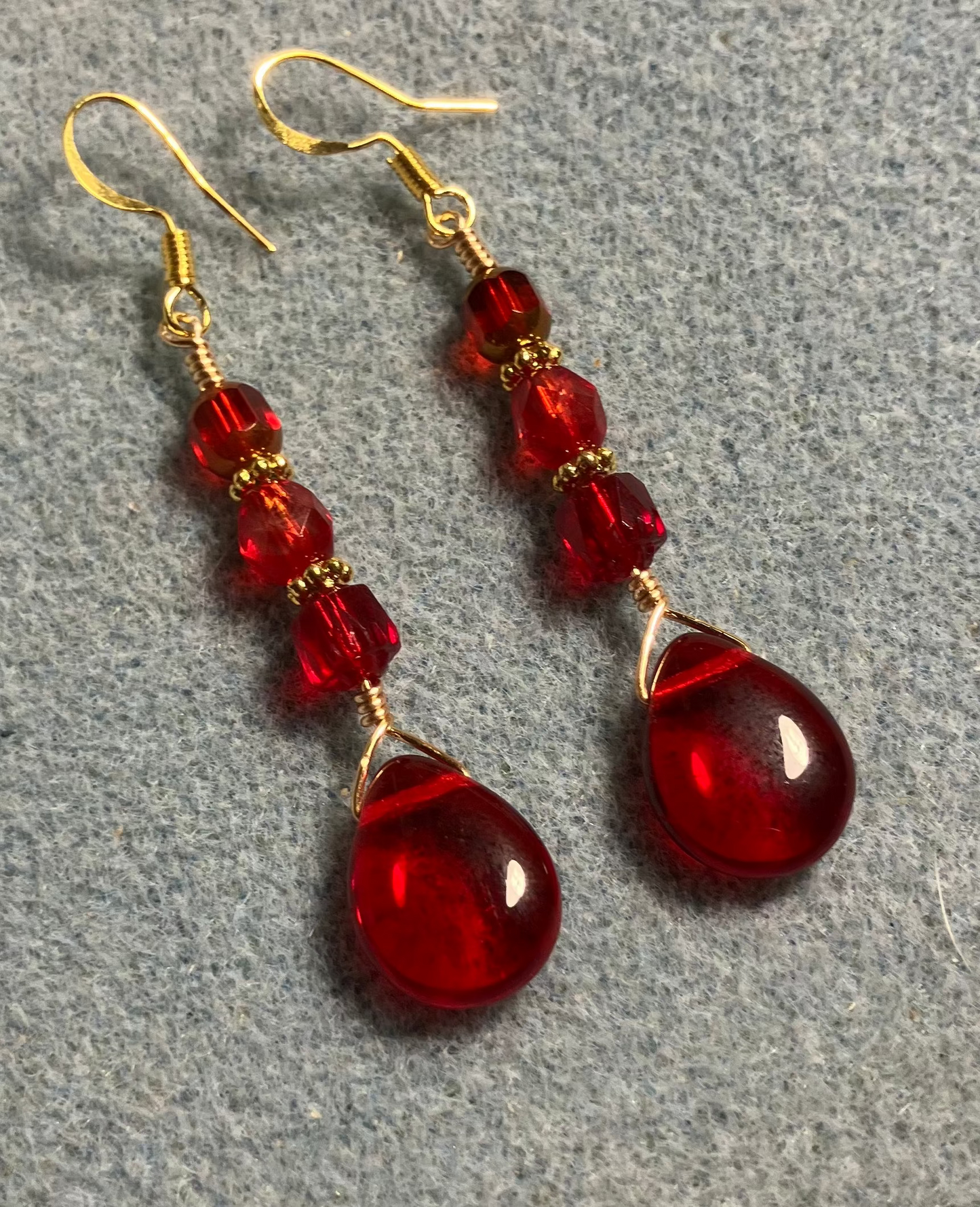 Bright red Czech glass pear drop bead earrings adorned with bright red Czech glass beads.